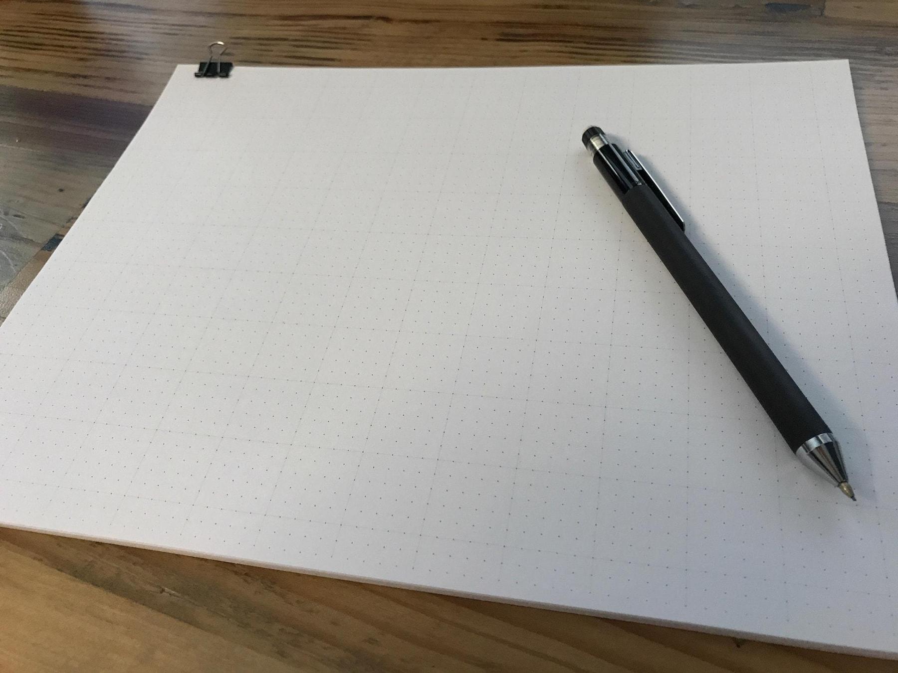 Dot paper on a desk with a mechanical pencil